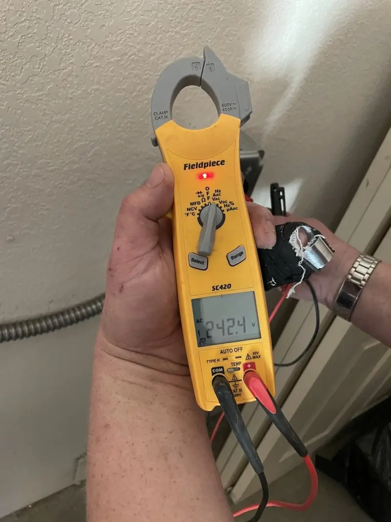 Voltage testing with clamp meter during Electrical Installation Services in Englewood